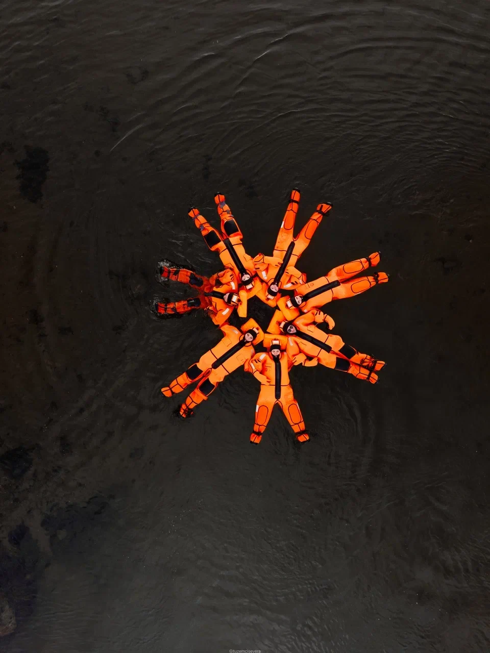 Ice floating guests in orange immersion suits